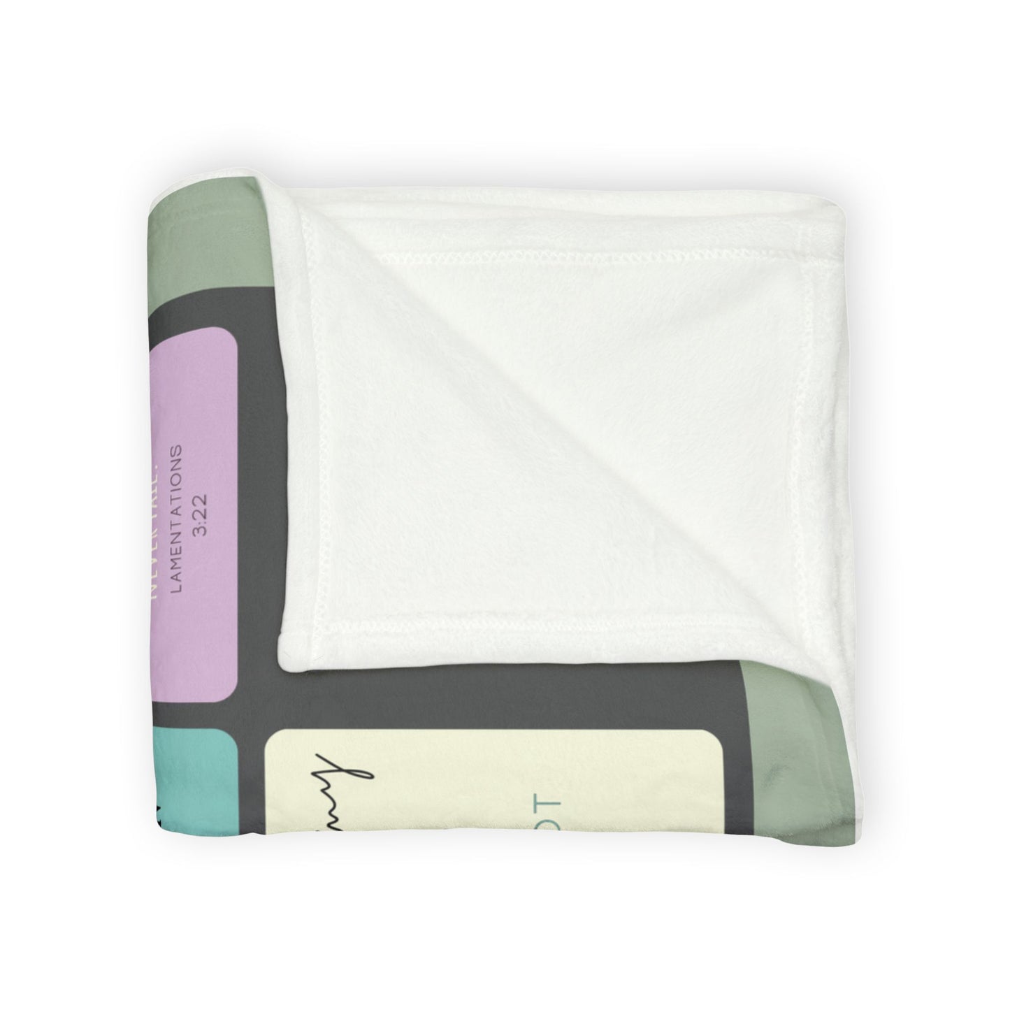 Folded Christian memorial blanket featuring an "In Loving Memory" scripture design with uplifting Bible verses, including a reference to Lamentations 3:22, in soft pastel tones with a cross and dove motif.