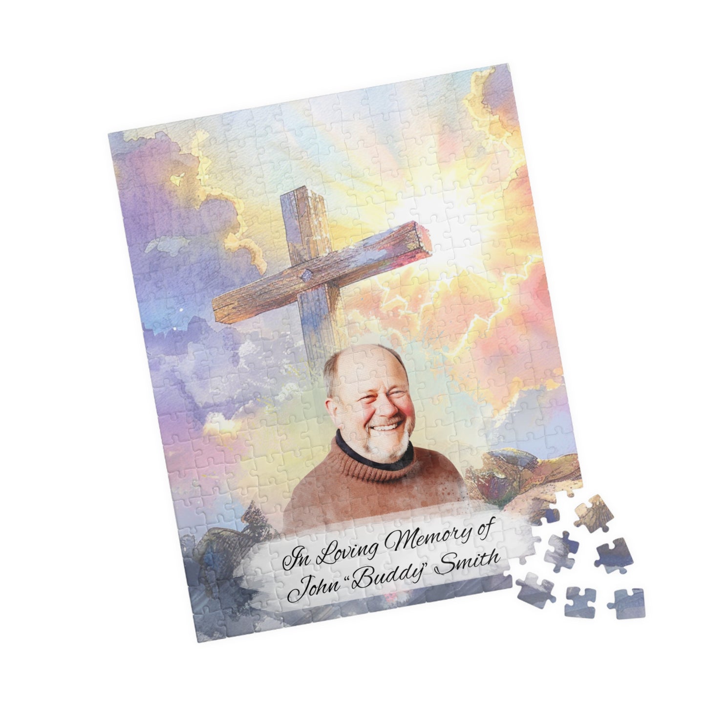 Custom memorial puzzle with a sacred cross keepsake design, featuring a photo of John "Buddy" Smith, personalized with "In Loving Memory of John 'Buddy' Smith," available in 252 or 520 pieces, set against a heavenly sky background with scattered pieces.