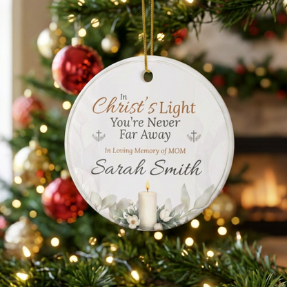 Decorative Christmas ornament with text and candle design, hanging on a decorated tree.