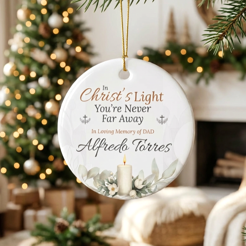 Memorial Christmas ornament with text and candle design, hanging in a festive setting.