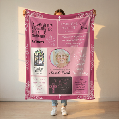 Person holding a pink memorial blanket with text and a photo of a woman.
